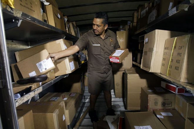 UPS driver Rafael Morales loads his truck before leaving the Olympic Hub near downtown Los Angeles on July 24. The company eyes the future as it nears its 100th birthday.