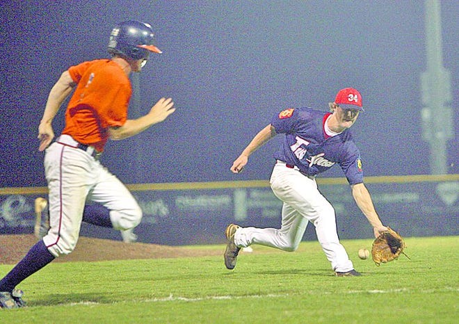 Tuscaloosa Post 34 pitcher John David Smelser, right, fields a bunt as Dothan's Brennan Olive runs to first Sunday in Tuscaloosa. Smelser tagged Olive out on the play.