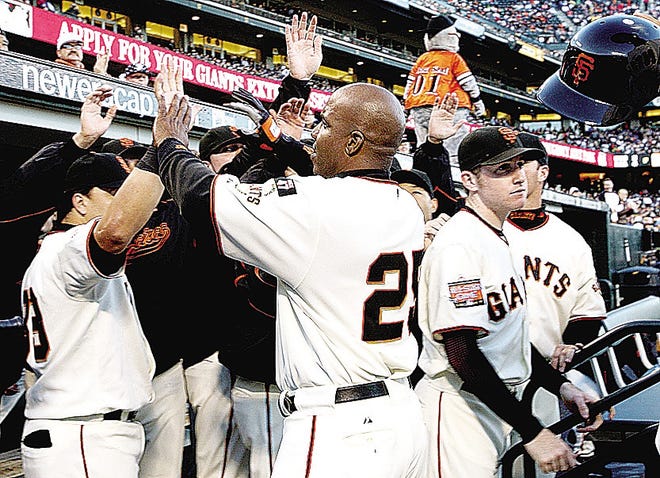 SAN FRANCISCO - AUGUST 7: Barry Bonds #25 of the San Francisco Giants is congratulated by teammates after scoring on a single hit by Benjie Molina #1 during the Major League Baseball game against the Washington Nationals on August 7, 2007 at AT&T Park in San Francisco, California. (Photo by Justin Sullivan/Getty Images)
