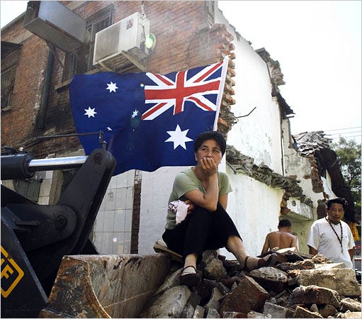 Sun Ruoyu, 55, sat on a bulldozer behind her family home. Ms. Sun, an Australian citizen, refuses to move out.