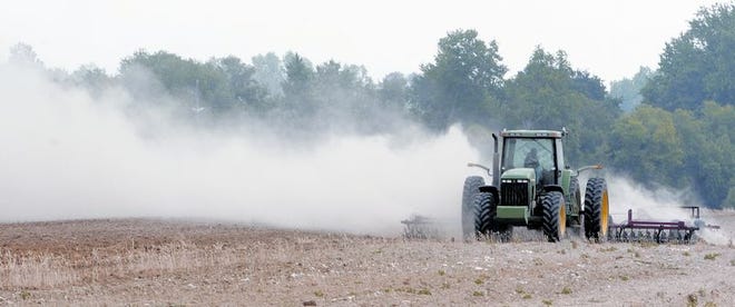 A tractor scatters dust as it moves across a field near Tifton, Ga., in May. As the South battles a drought, Rep. Terry Evertt, R-Ala., has submitted a proposal for helping the region’s farmers build reservoirs.