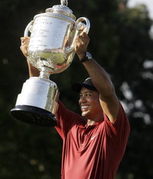 Tiger Woods holds up the Wannamaker Trophy after winning the PGA Championship.