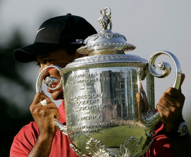 Tiger Woods holds up the Wanamaker Trophy after winning the 89th PGA Championship at the Southern Hills Country Club in Tulsa, Okla., on Sunday. Tiger won his 13th major tournament with an 8-under-par.