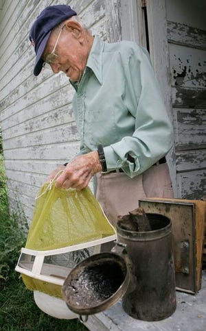 Waldo McBurney, 104, prepares to work with bee hives at his home Aug. 7 in Quinter, Kan. He was recently declared America's oldest worker.