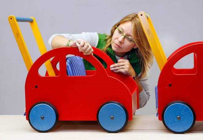 Supervisor Katrin Buettner checks a children's roller car in the Haba toy company in Bad Rodach on Tuesday.