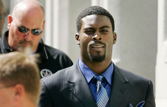 Escorted by U.S. Marshals, Atlanta Falcons quarterback Michael Vick, right, leaves the federal courthouse in Richmond, Va., following his arraignment.