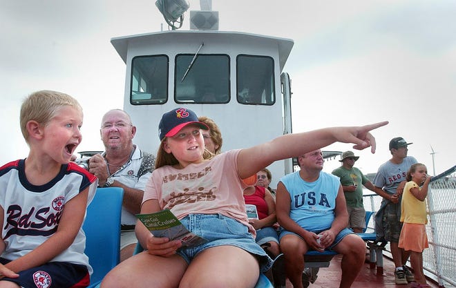 Kayla Johnson (CENTER), 10, points out a ship to her little brother Casey Johnson (LEFT), 6, during a 2-hour Cape Cod Canal cruise aboard The Viking, which sails out of Onset harbor.Kids get to travel free on the afternoon cruises.