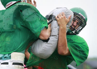 North Boone High School's Anthony Krawczyk (right) works on a defensive play during a recent practice.