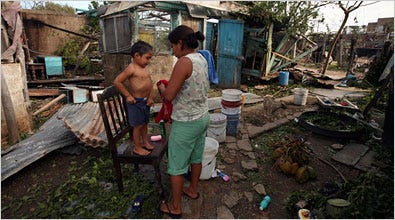 Marlene Tun Hoi dressed her son Leonardo, 3, on Tuesday amid the rubble Hurricane Dean left of their home in Chetumal, Mexico.