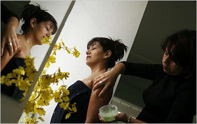 Gilma Santos gets a shoulder treatment from Sandra Rojas, a spa manager in São Paulo, Brazil.