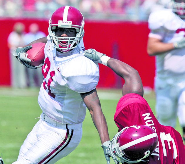 Alabama receiver Keith Brown tries to elude the grasp of Crimson Tide defensive back Kareem Jackson during Alabama’s A-Day game in April.