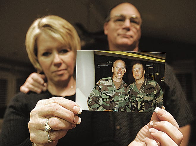 ** FILE ** This is a Nov. 17, 2005 file photo of Peggy and Jeff Hubbard holding up a photograph of their sons Jason, left, and Nathan, taken in Clovis, Calif. Army Spc. Nathan Hubbard was killed in a helicopter crash in Iraq on Wednesday, Aug. 22, 2007. Nathan Hubbard had joined the Army after his brother Marine Lance Cpl. Jared Hubbard was killed in Iraq in 2004. (AP Photo/Fresno Bee, Tomas Ovalle)