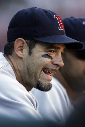 Boston Red Sox's Mike Lowell smiles as he watches his teammates play against the Chicago White Sox during the ninth inning of a baseball game, Sunday, Aug. 26, 2007, in Chicago. The Red Sox won 11-1