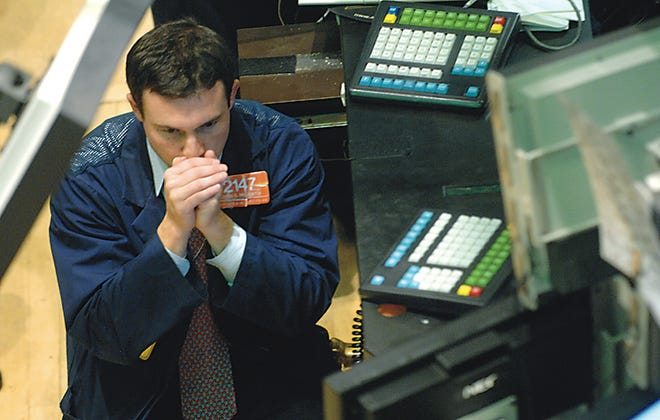 Charles McGrath watches the early numbers from the floor of the New York Stock Exchange, Tuesday, Aug. 28, 2007, in New York. Wall Street extended its retreat as investors cautiously awaited minutes from the Federal Reserve's last meeting that could provide insight into whether it may cut rates. The Dow Jones industrials dropped more than 100 points.