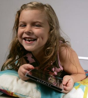 Halee Dinger, 5, of Rockford shows off the Daughtry CD she got from the Tooth Fairy.
