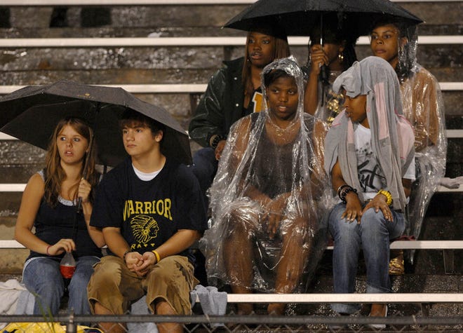 Jefferson County fans try to stay dry as they watch their Warriors take on visiting Burke County in the home opener.
