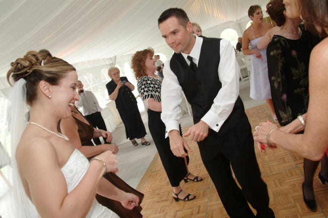 Megan McCarthy of Southborough and Robert Brodeur of Southbridge laugh as they dance at a reception at the Wayside Inn in Sudbury.