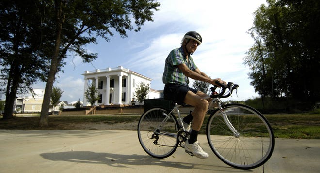Bill Wilkerson, of North Augusta, bikes along the North Augusta Greeneway in front of the Hammond's Ferry neighborhood.
