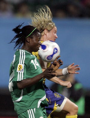 Nigeria's Faith Ikidi (left) and Sweden's Victoria Svensson battle for control in their Women's Word Cup match.