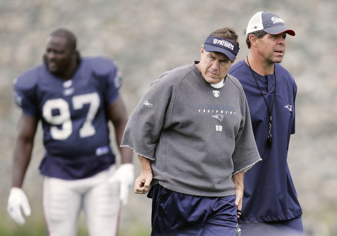 New England Patriots head coach Bill Belichick, center, walks with strength and conditioning coach Mike Woicik, right, during football practice, Wednesday, Sept. 12, 2007, in Foxborough, Mass. (AP Photo/Michael Dwyer)