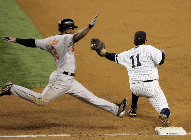 The Orioles' Melvin Mora strides toward first base trying to beat the throw from Yankees third baseman Alex Rodriguez in the fifth-inning at Yankee Stadium. First baseman Doug Mientkiewicz received the throw in time to nab Mora in the Yankees' win.