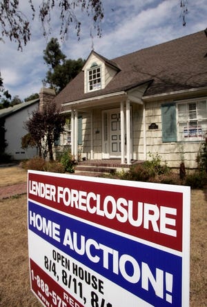 A home is advertised for sale at a foreclosure auction in Pasadena, Calif.