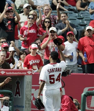 Los Angeles Angels pitcher Ervin Santana tips his cap to the fans as he comes out of the game in the seventh inning. Santana struck out 10 in the victory, giving the Angels their 90th win of the year.