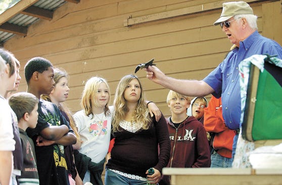 Ron Schroeder of Henrietta, a retired DEC wildlife technician use a rubber bat for a demonstration during his topic "Wildlife" Detectives" at the Annual Ontario County Conservation Field Days at 4-H Camp Bristol Hills on Wednesday.