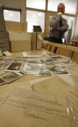 Andrew Wentink, curator of Middlebury College’s special collections, stands behind photographs, letters, and journals written by Ernest Hemingway and members of his family. Middlebury recently acquired the papers from the author’s niece and her husband.