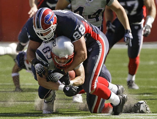 The Patriots’ Wes Welker is tackled by the Bills’ Ryan Neufeld at the end of a punt return in the second quarter.