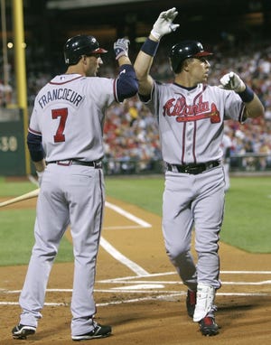 Atlanta's Mark Teixeira is congratulated by Jeff Francoeur after hitting a three-run home run off Philadelphia starter Jamie Moyer during the first inning Tuesday.