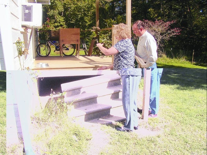 Dianne Hall and Robert Whittaker of Hendersonville First Baptist Church survey a set of steps to be repaired during a past Operation Inasmuch effort.