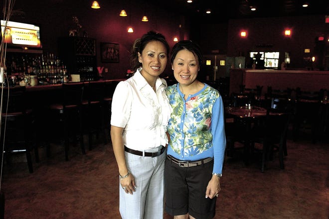 Debbie Thongsavanh, right, and her sister Sue Xaisanasy-Chen, left, stand in the seating area of their new restaurant, Jasmine’s Asian Fusion, an Asian style restaurant in Webster at 657 Ridge Road in the Empire-Ridge Center plaza.