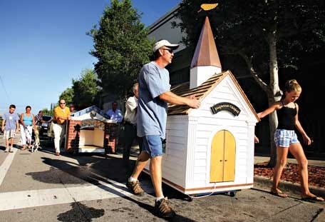 Some of the houses are paraded through downtown Ocala to the old library building.