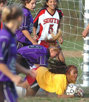 South goalkeeper Theresa Loch holds her ground in making a save during St. Peter-Marian’s 8-0 girls’ soccer victory.
