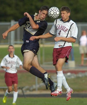 East Bridgewater’s James Adams, left, and Carver’s Paul Beaulieu battle for the ball during a 1-1 tie Wednesday.