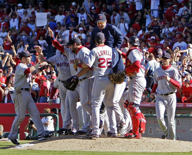 The Red Sox celebrate after the final out of their sweep of the Angels.