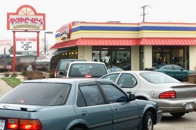 Vehicles clog the entrance to the Popeyes Restaurant on North Second Street in Loves Park in March 2000.