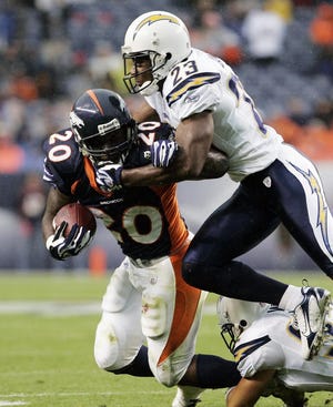 Denver Broncos running back Travis Henry (20) is tackled by San Diego Chargers cornerback Quentin Jammer (23) during the second half of an NFL football game Sunday, Oct. 7, 2007, in Denver. The Chargers beat the Broncos 41-3. (AP Photo/Jack Dempsey)