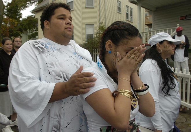 Kiara Colon, 17, Brockton, right, sister of Shaian Colon, cries as she is comforted by Angel Santiago, 21, Brockton, during the memorial walk for Shaian A. Colon, 17, Brockton.