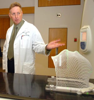 Dr. Mark Vasa, who was killed in an accident Monday, displays the new TomoTherapy unit at an open house in this April 12 photo.