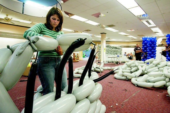 Karen McIntyre of Rochester works on assembling a wall for Balloon Manor, a massive haunted house sculpted entirely from balloons.