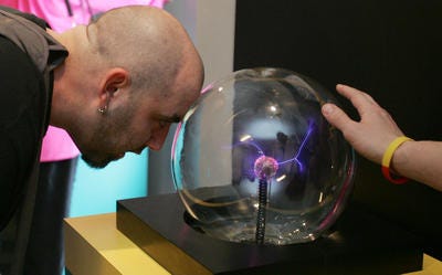 Chef Duff Goldman of the Food Network show "Ace of Cakes" tests out the plasma globe in the Discovery Center Museum in Rockford.