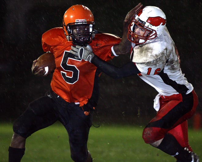 Marlborough wide receiver Graham Asum (left) delivers a stiff arm to Milford's Alex Avery during their clash that was postponed after a power failure at Kelleher Field.