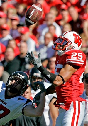Wisconsin defensive back Shane Carter intercepts a pass in front of Northern Illinois wide receiver Greg Turner Saturday, Oct. 20, in Madison, Wis.