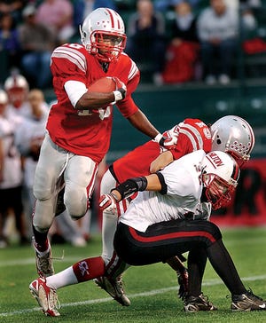 Canandaigua's Kaheem Gist, left, follows his blockers during Friday evening's 56-39 win in the Class AA semifinals played at PAETEC Park (10/19/07). Gist recorded a Section V-record 449 yards and seven TD's on 37 carries.