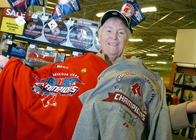 Loretta Morrison of Weymouth bought sweatshirts and T-shirts for her sons on Monday as fans hurried to buy Red Sox gear at the Sports Authority store in Braintree following the team’s four-straight World Series victory over the Colorado Rockies.