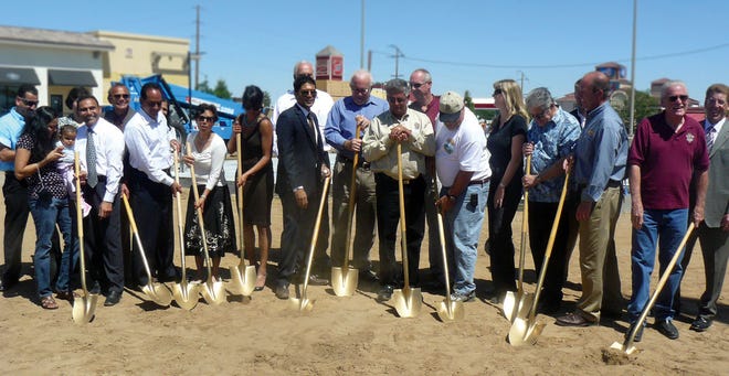 Farmer Boys restaurant project members and dignitaries perform a ceremonial tossing of the dirt during Wednesday's groundbreaking event at the High Desert Gateway Center in Hesperia.