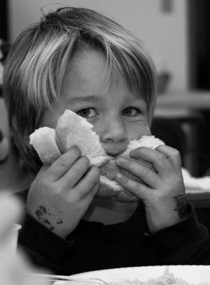 Parker Shipman enjoys bread at the Paxton Center School Band spaghetti dinner last Friday. Joyce Roberts photo