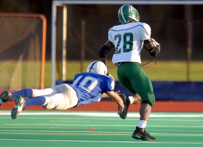Dolgeville's Kyle LaGrange, left, dives but cannot reach Onondaga's Latavius Murray as he return a first quater punt 75-yards for a touchdown during the Section III Class D football championship game, Friday, Nov. 2, 2007, at the Michael J. Bragman Athletivc Complex in Cicero.